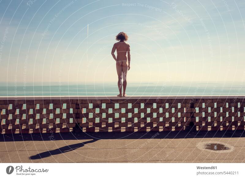 Italy, Jesolo, Rear view of nude man standing on balustrade caucasian caucasian ethnicity caucasian appearance european rear view back view view from the back
