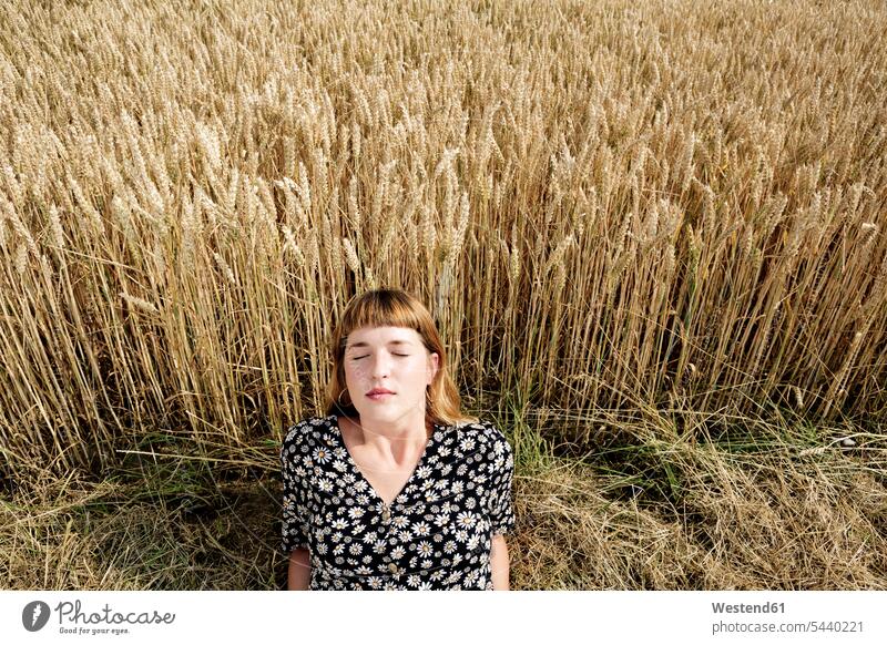 Portrait of young woman with eyes closed relaxing in front of grain field human human being human beings humans person persons 1 one person only only one person