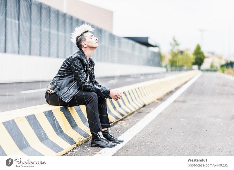 Punk woman sitting at the roadside with closed eyes punk punks Seated Road Side females women subculture people persons human being humans human beings streets