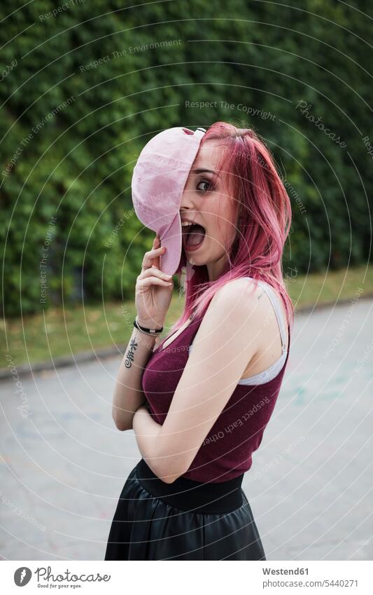 Portrait of cheerful young woman with dyed hair outdoors portrait portraits females women Adults grown-ups grownups adult people persons human being humans