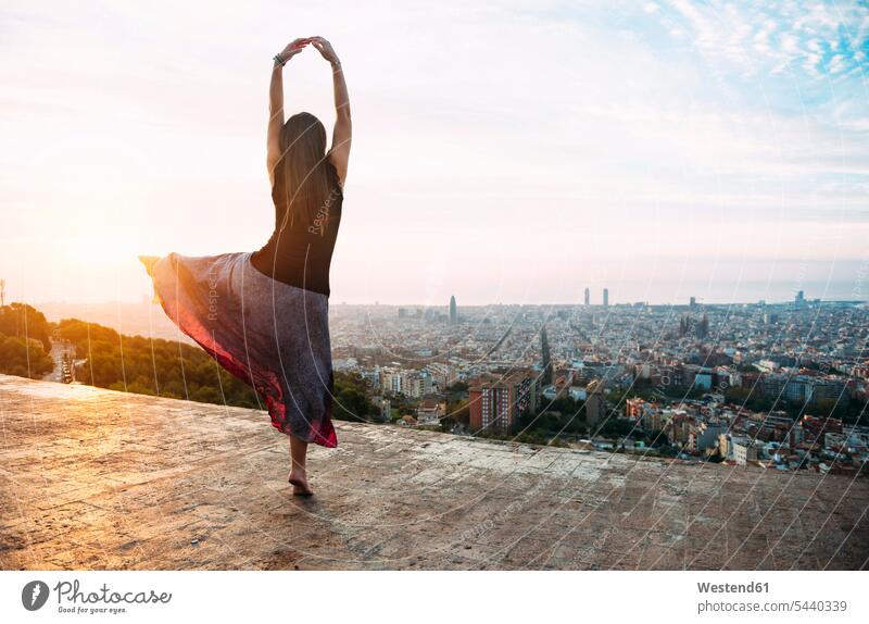 Spain, Barcelona, Woman ldancing at view point over city woman females women morning in the morning View Vista Look-Out outlook sunrise sun rise sunrises Adults