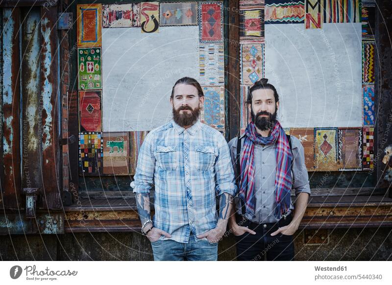 Portrait of two bearded friends standing side by side with hands in their pockets portrait portraits friendship Hamburg man men males Old Warehouse District