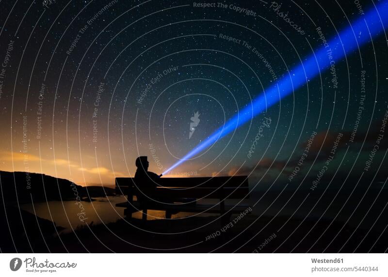 Spain, Ortigueira, Loiba, silhouette of a man sitting on bench under starry sky with blue ray benches tranquility tranquillity Tranquil Scene silhouettes