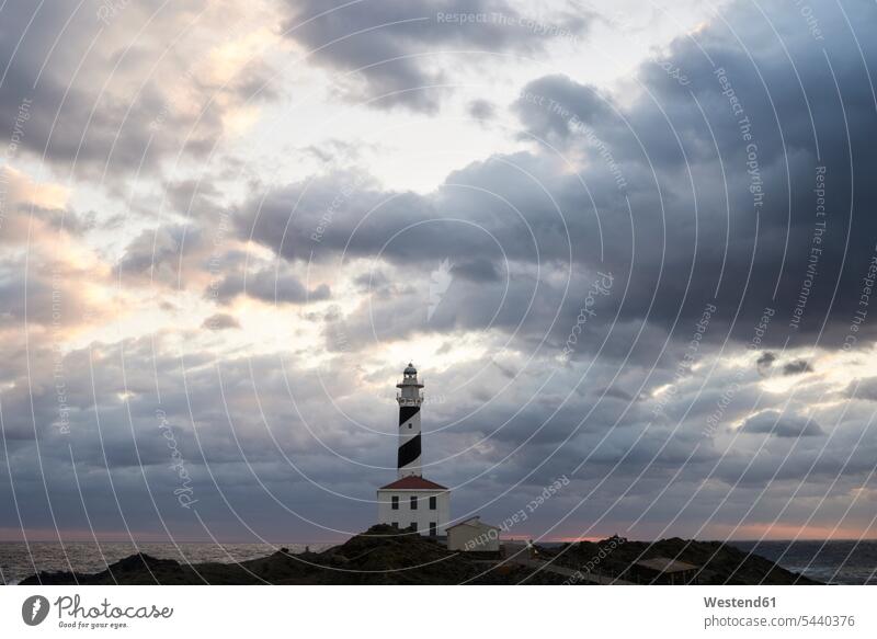Spain, Balearic Islands, Menorca, Favaritx lighthouse surrounded by clouds in the morning coast coastline coast area Seacoast seaside lighthouses light houses