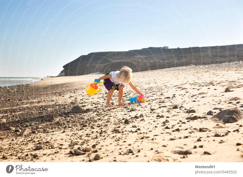 Spain, Fuerteventura, girl playing on the beach females girls beaches child children kid kids people persons human being humans human beings vacation Holidays