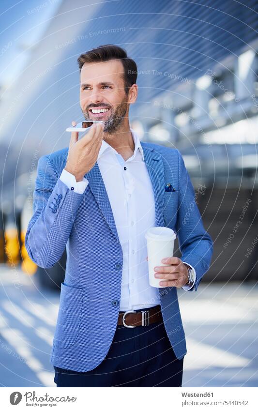Portrait of smiling businessman with phone and coffee in the city on the phone call telephoning On The Telephone calling Coffee smile mobile phone mobiles