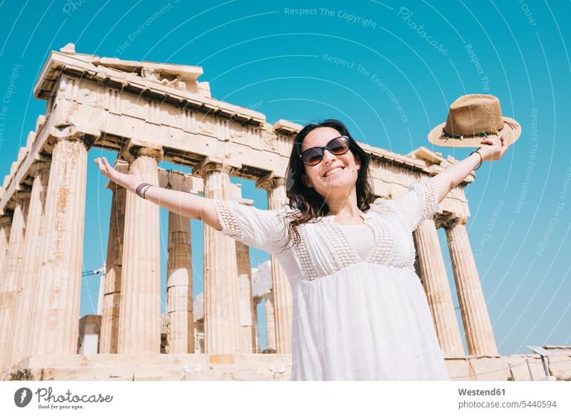 Greece, Athens, happy woman visiting the Parthenon temple on the Acropolis happiness smiling smile female tourist females women Attica tourists tourism