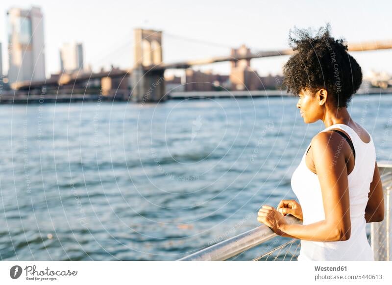 USA, New York City, Brooklyn, woman standing at the waterfront River Rivers bridge bridges females women waters body of water Adults grown-ups grownups adult