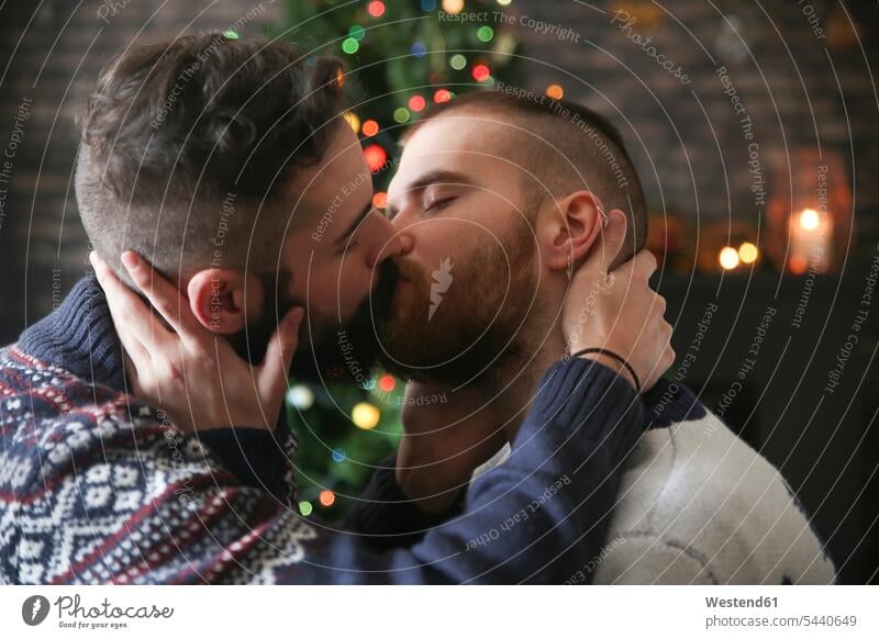 Kissing gay couple at Christmas time at home Gay Couple Gays X-Mas yule Xmas X mas kissing kisses same-sex couple woman and woman women and women