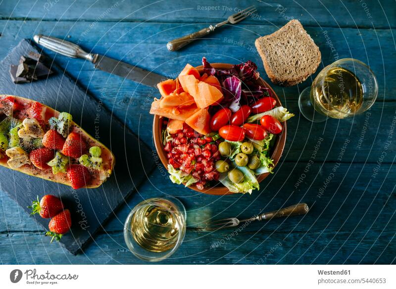 Salad with tomato, pomegranate, papaya and olives, with papaya and glass of wine white wine glass white wine glasses Strawberry Strawberries Fragaria Snack