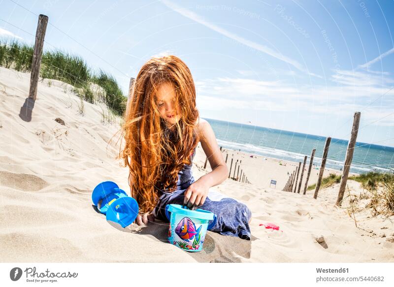 Netherlands, Zandvoort, redheaded girl playing on the beach beaches red hair red hairs red-haired females girls people persons human being humans human beings