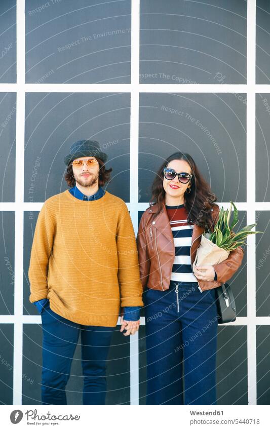Portrait of young couple hand in hand portrait portraits twosomes partnership couples people persons human being humans human beings sunglasses sun glasses