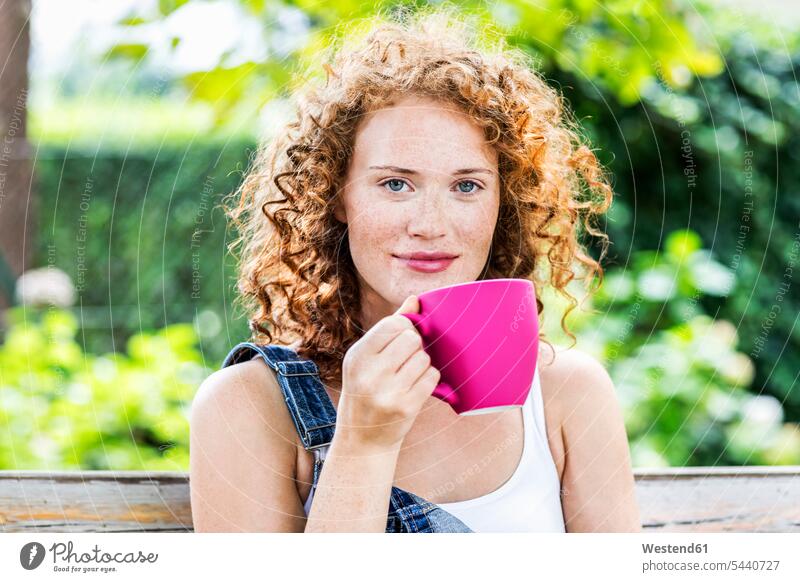 Portrait of redheaded young woman with pink coffee cup Coffee Cup Coffee Cups females women portrait portraits Dishes Crockery Tableware Adults grown-ups