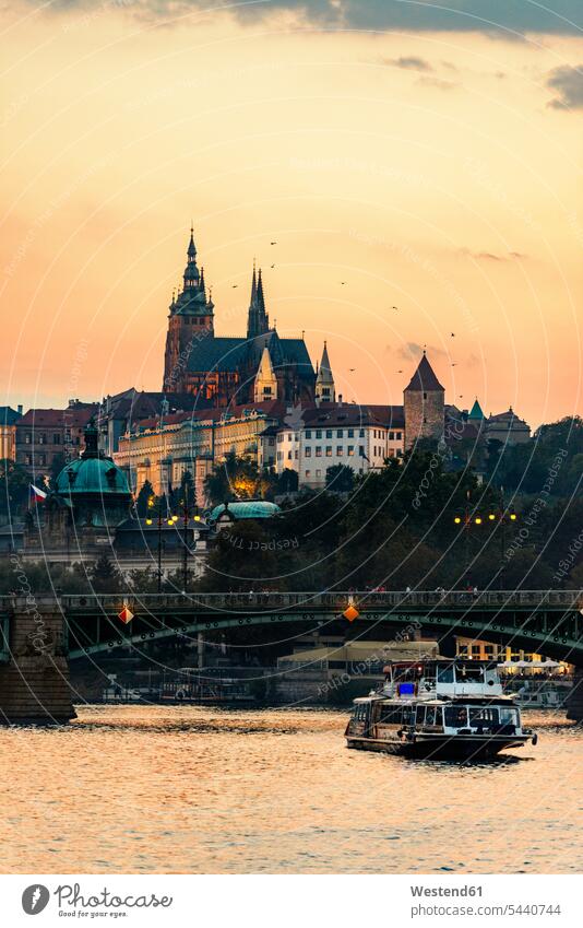 Czechia, Prague, view to castle and Charles Bridge with Vltava in the foreground at sunset city view city pictures city views urban view of the city City Views