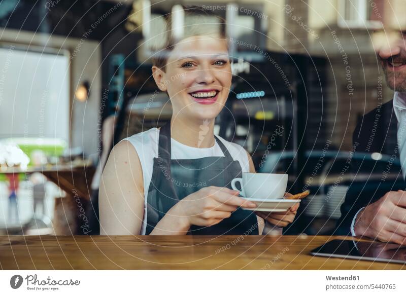 Smiling waitress serving coffee to customer in cafe Coffee smiling smile waitresses Businessman Business man Businessmen Business men portrait portraits Drink