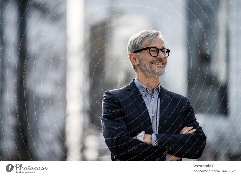 Smiling grey-haired businessman outdoors Businessman Business man Businessmen Business men portrait portraits smiling smile business people businesspeople