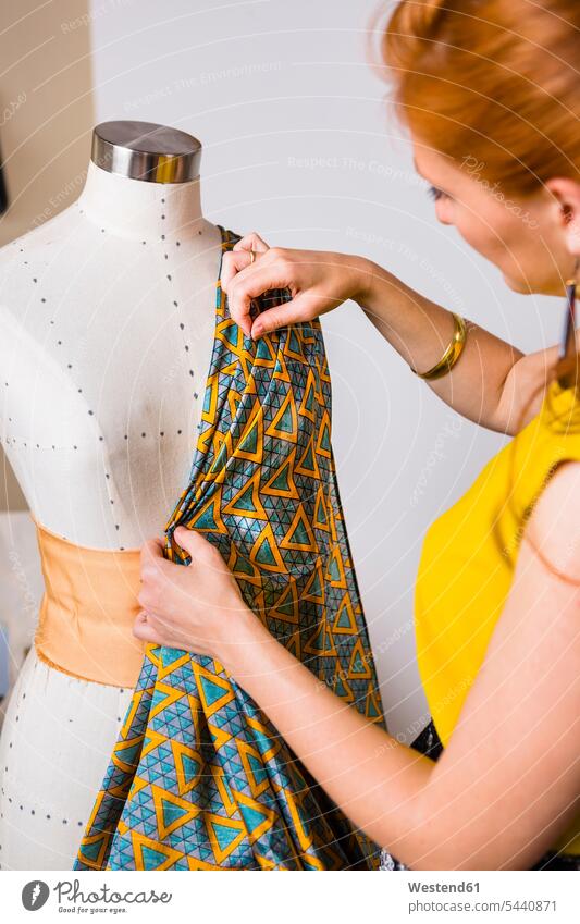 Fashion designer working at mannequin seamstress seamstresses Fashion Designer woman females women tailor dressmakers tailors craftsman trade craftsmen