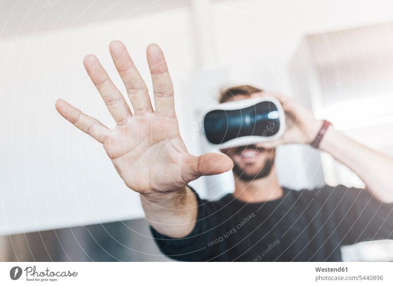 Man wearing Virtual Reality Glasses hand human hand hands human hands men males VR glasses Virtual-Reality Glasses virtual reality headset vr headset vr goggles