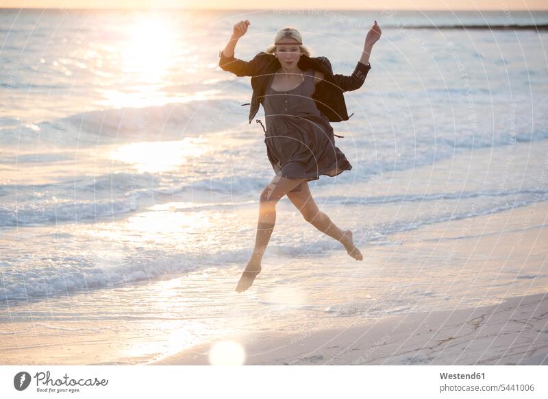 Young woman jumping for joy on the beach happiness happy getting away from it all Getting Away From All unwinding relaxing Sea ocean running beaches vacation