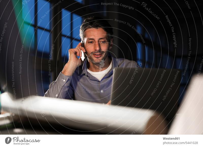 Man working late in office Businessman Business man Businessmen Business men males on the phone call telephoning On The Telephone calling offices office room