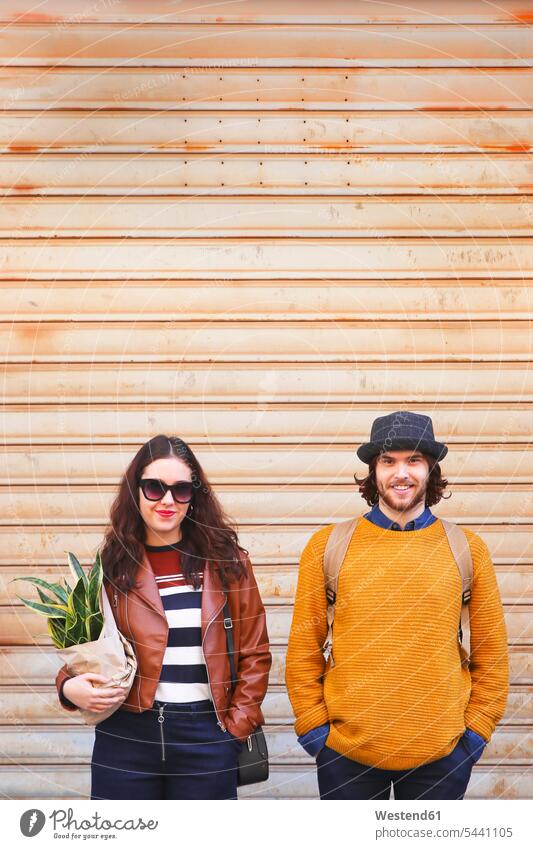 Portrait of young couple standing side by side twosomes partnership couples people persons human being humans human beings portrait portraits smiling smile