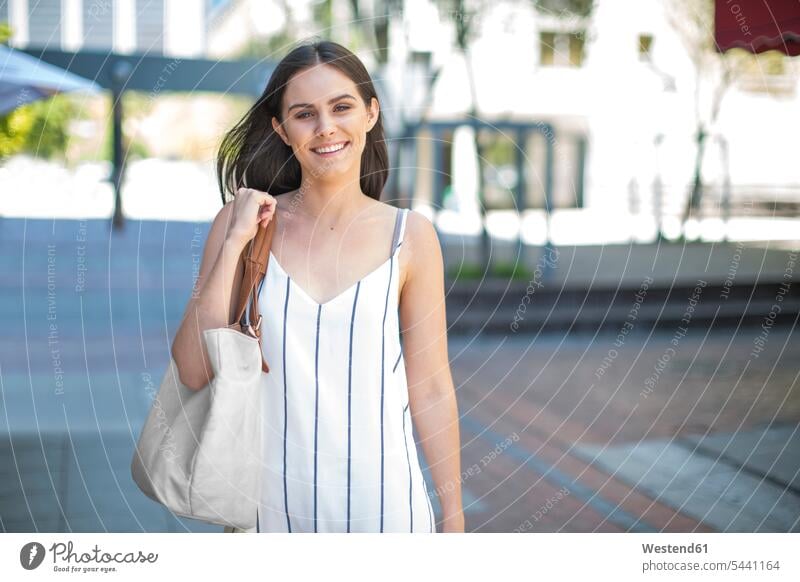 Portrait of smiling young woman in the city happiness happy smile females women Adults grown-ups grownups adult people persons human being humans human beings