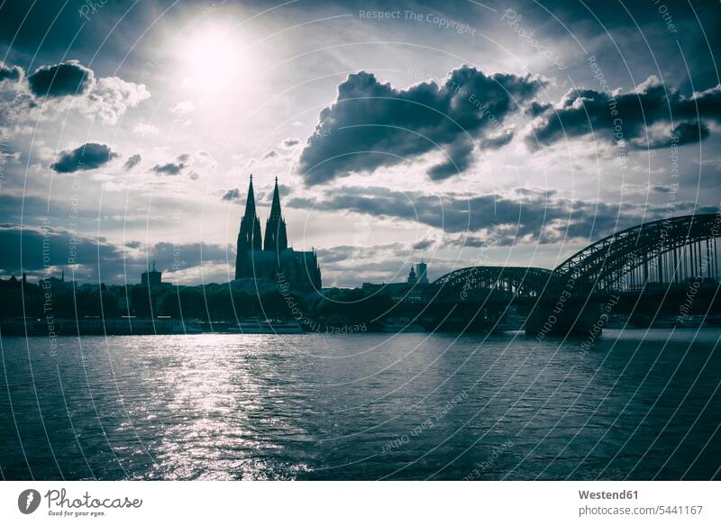 Germany, Cologne, Cologne cathedral in backlight cloud clouds bridge bridges Sun Travel destination Destination Travel destinations Destinations nobody landmark