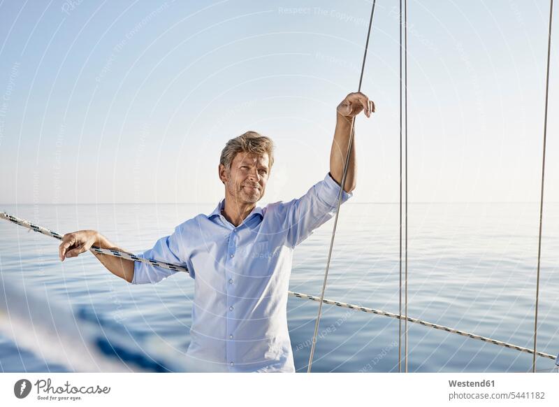 Portrait of mature man on his sailing boat men males portrait portraits Adults grown-ups grownups adult people persons human being humans human beings