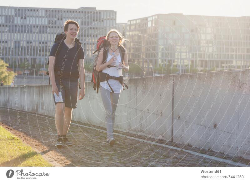 Germany, Berlin, Young couple traveling Berlin with backpacks Sightseeing Traveller Travellers Travelers visiting viewing Teenager Teens backpacker Backpackers