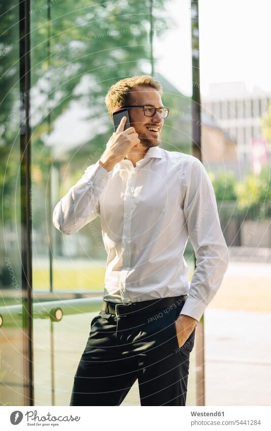Smiling businessman talking on cell phone business life business world business person businesspeople Business man Business men Businessmen telecommunication