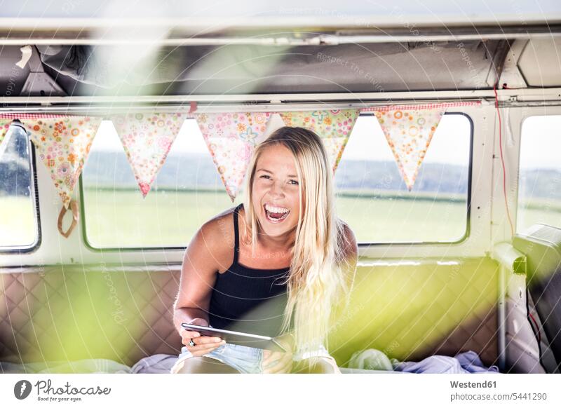 Carefree woman with tablet inside a van females women Fun having fun funny digitizer Tablet Computer Tablet PC Tablet Computers iPad Digital Tablet