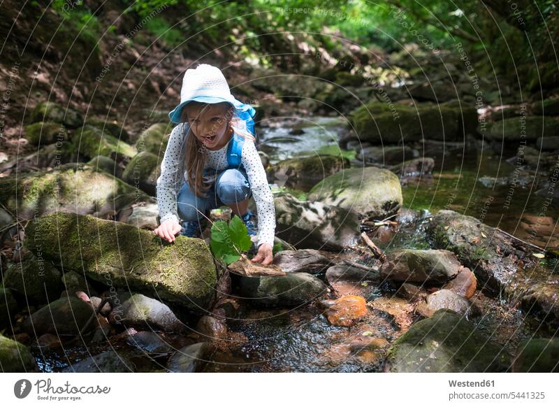Little girl playing at brook in the woods females girls brooks rivulet child children kid kids people persons human being humans human beings water waters