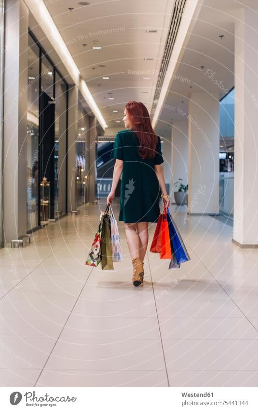 Young woman with shopping bags female customer indoors indoor shot Interiors indoor shots interior view shopping spree shopping expedition clientele clients