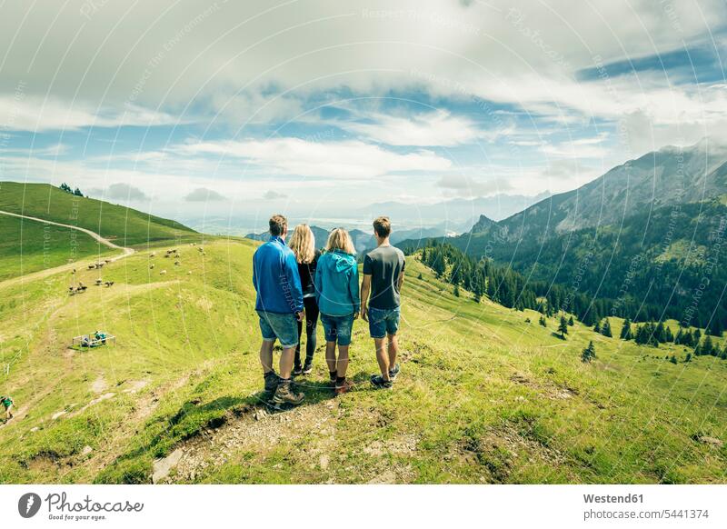 Germany, Bavaria, Pfronten, family enjoying the view on alpine meadow near Aggenstein standing families View Vista Look-Out outlook people persons human being