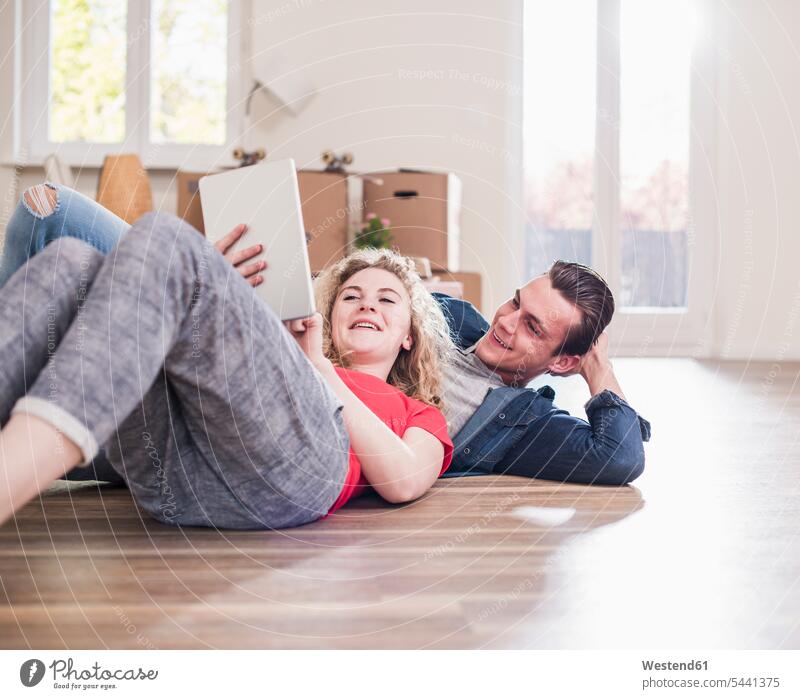 Happy young couple in new home lying on floor with tablet break digitizer Tablet Computer Tablet PC Tablet Computers iPad Digital Tablet digital tablets