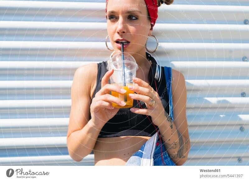 Portrait of tattooed young woman with soft drink portrait portraits drinking females women Adults grown-ups grownups adult people persons human being humans