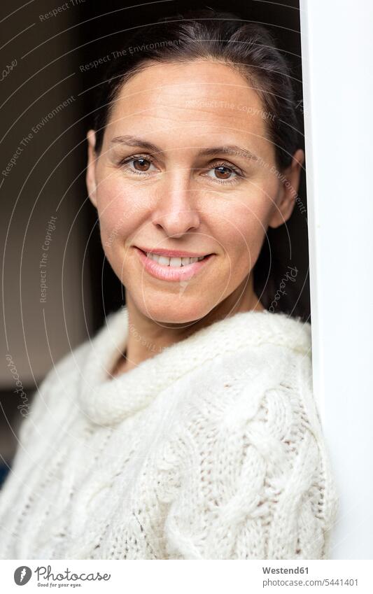 Portrait of smiling mature woman wearing knit pullover portrait portraits females women Adults grown-ups grownups adult people persons human being humans
