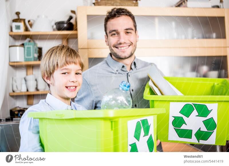 Father and son at home with waste boxes Rubbish recycling ecology recycle smiling smile sons manchild manchildren father pa fathers daddy dads papa family