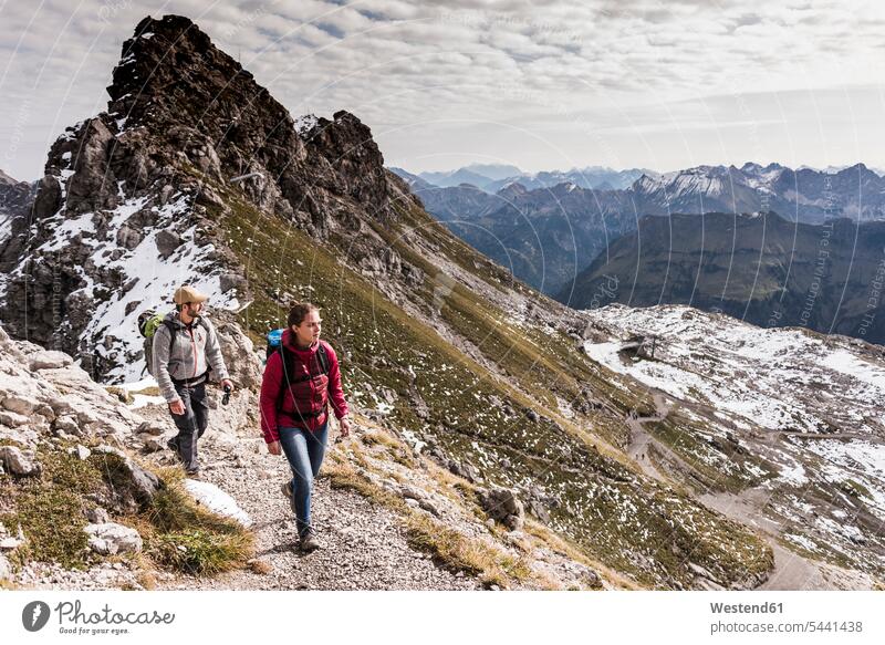 Germany, Bavaria, Oberstdorf, two hikers walking in alpine scenery mountain range mountains mountain ranges going hiking couple twosomes partnership couples