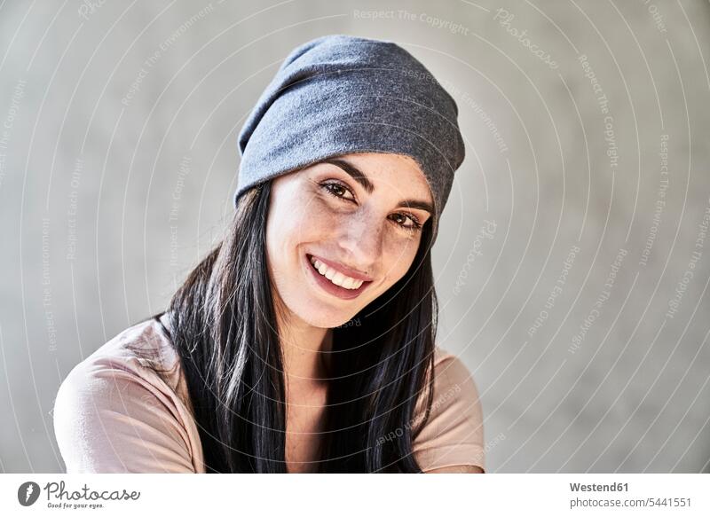 Portrait of smiling young woman wearing beanie smile portrait portraits females women Adults grown-ups grownups adult people persons human being humans