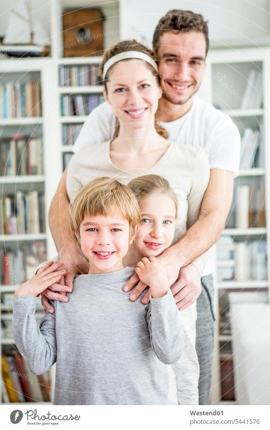 Portrait of active family at home sportive sporting sporty athletic smiling smile families sports people persons human being humans human beings two parents