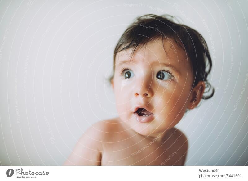 Surprised baby girl on white background amazed surprised amazement infants nurselings babies portrait portraits surprising Emotion Feeling Feelings Sentiments