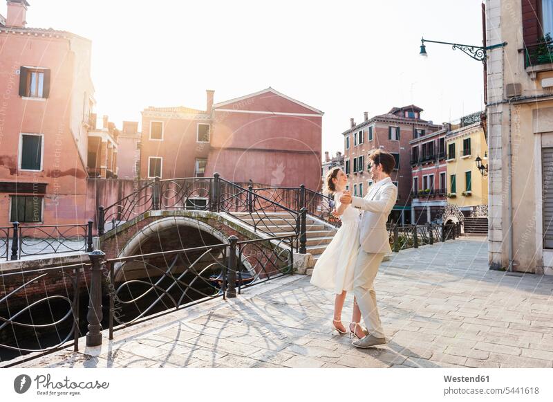 Italy, Venice, dancing bridal couple at sunrise dance twosomes partnership couples people persons human being humans human beings lovers sun rise sunrises