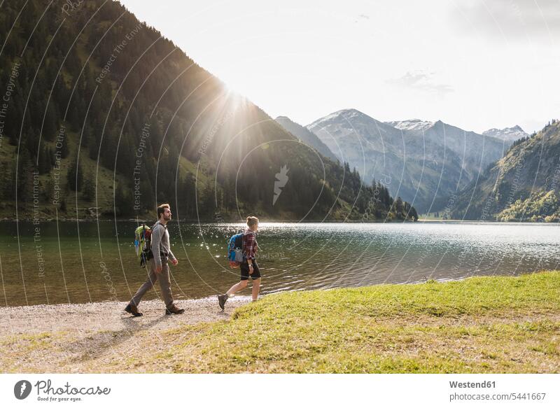Austria, Tyrol, young couple hiking at mountain lake mountain lakes hike twosomes partnership couples mountains water waters body of water people persons