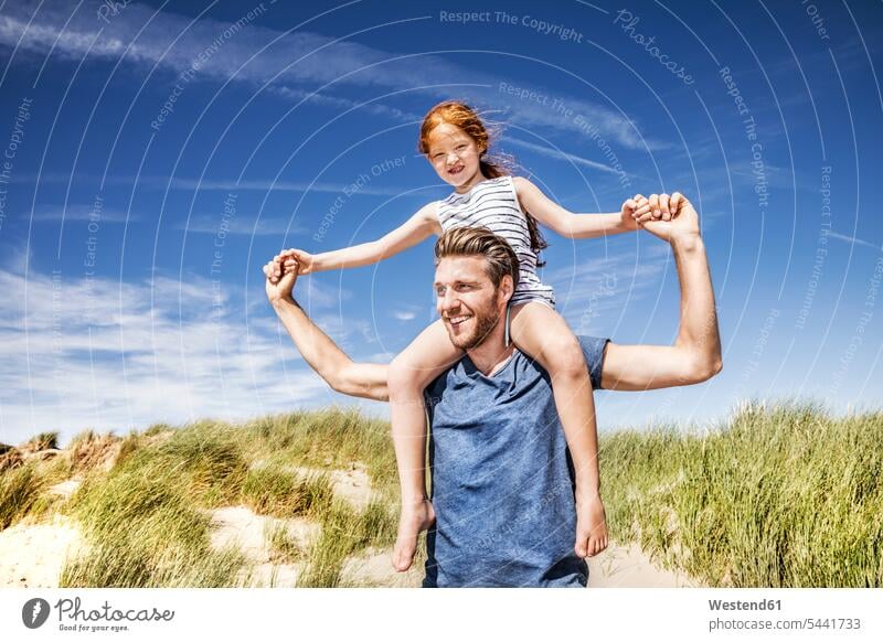 Netherlands, Zandvoort, father carrying daughter on shoulders in beach dunes beaches daughters happiness happy family families sand dune sand dunes Fun