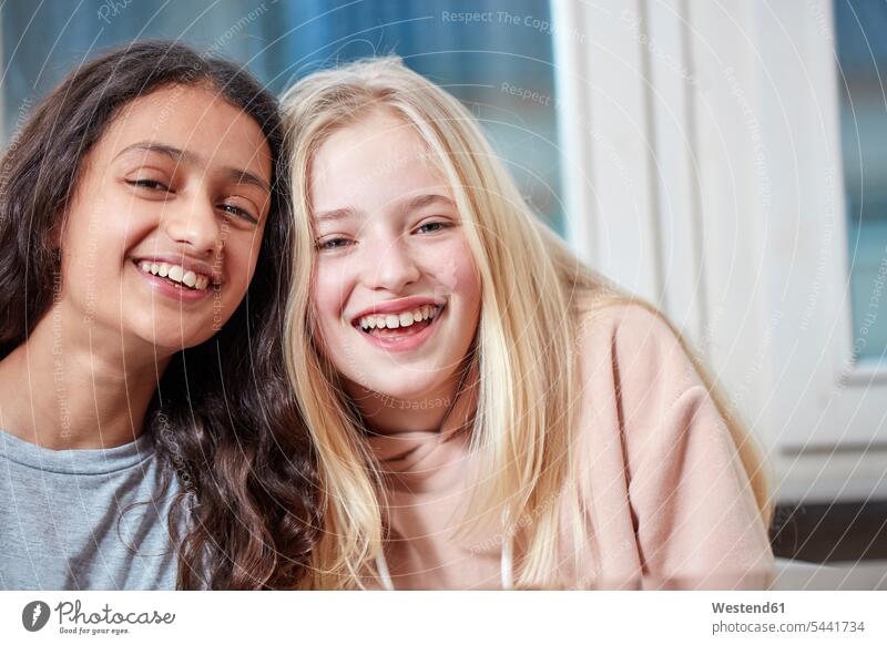 Portrait of two happy girls side by side females portrait portraits laughing Laughter female friends child children kid kids people persons human being humans