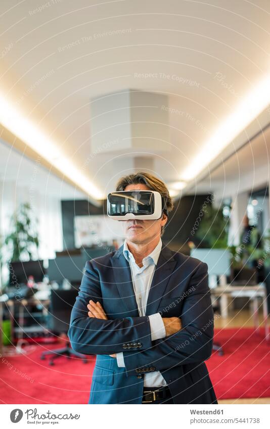 Businessman wearing VR glasses in office offices office room office rooms virtual reality Virtual Reality Glasses Virtual-Reality Glasses