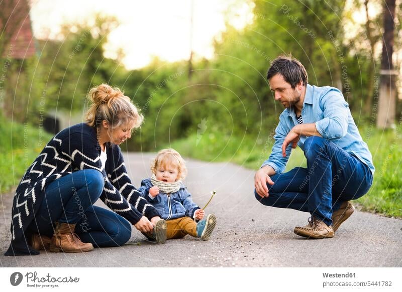 Cute little boy with parents on field path baby infants nurselings babies people persons human being humans human beings family families portrait portraits