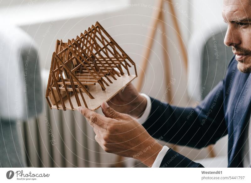 Architect examining architectural model models looking eyeing architects man men males view seeing viewing occupation profession professional occupation jobs
