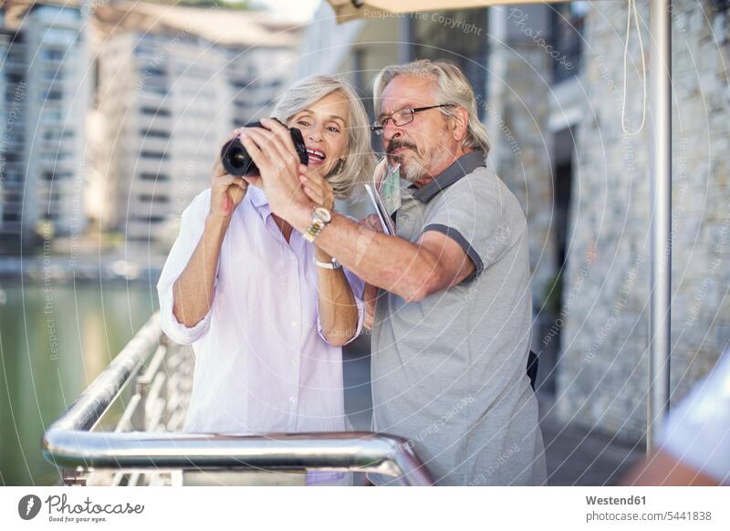 Senior couple taking a city break, taking photos twosomes partnership couples photographing City Break City Trip Urban Tourism happiness happy on the move